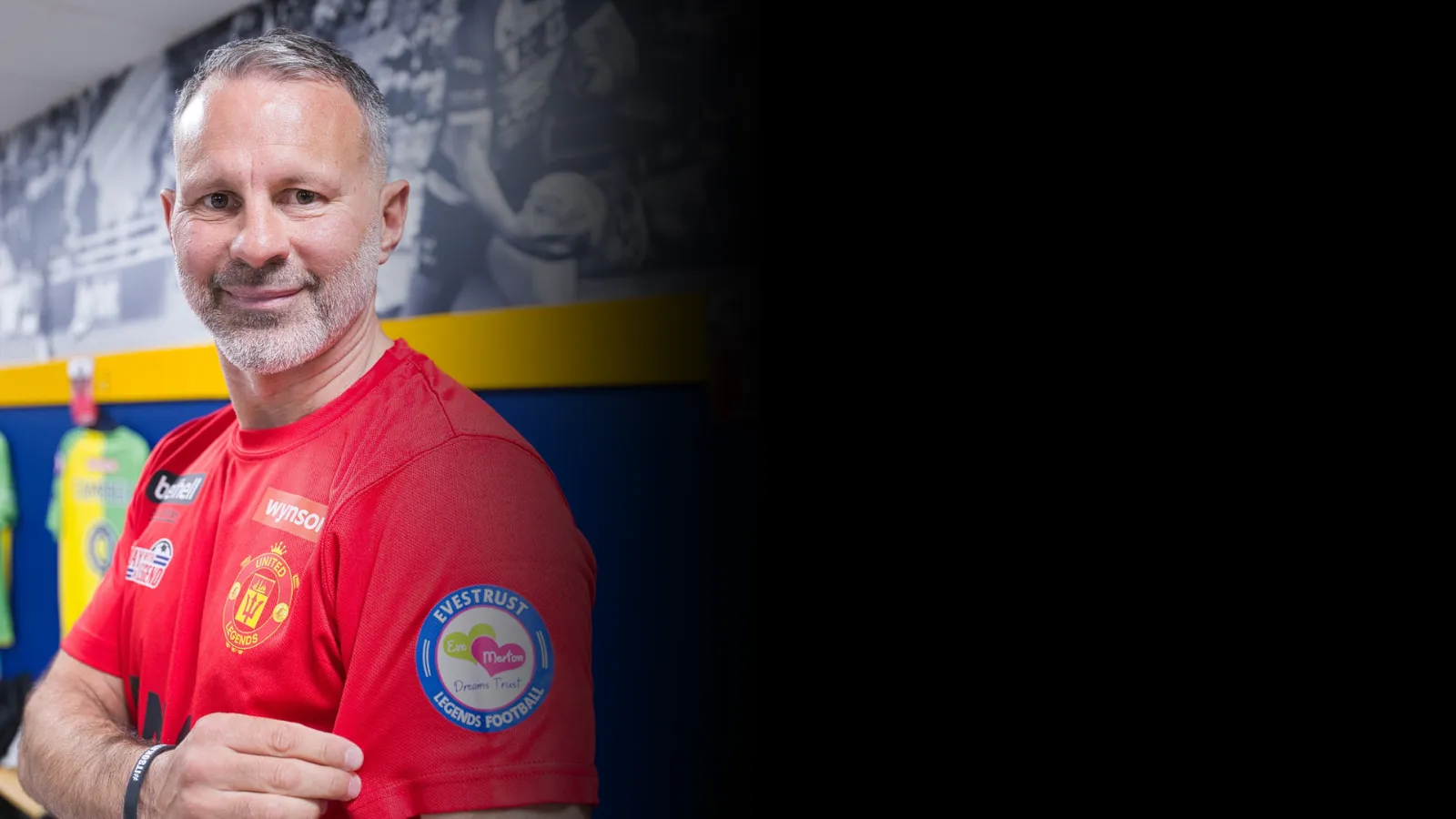 Ryan Giggs holding the Evestrust badge at Legends football